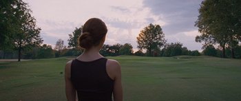 Movie still from “To the Wonder” (2012), directed by Terrence Malick – A woman standing in front of a green field; Medium shot, Low angle