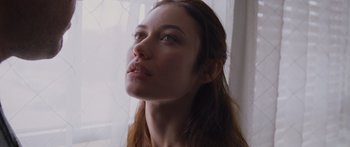 Movie still from “To the Wonder” (2012), directed by Terrence Malick – A person with long brown hair; Close Up shot, Low angle