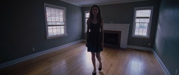 Movie still from “To the Wonder” (2012), directed by Terrence Malick – A woman in a black dress is walking in a room; Wide shot, High angle
