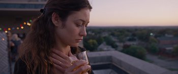 Movie still from “To the Wonder” (2012), directed by Terrence Malick – A woman is holding a glass of wine in her hands; Close Up shot, Over the shoulder angle