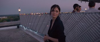 Movie still from “To the Wonder” (2012), directed by Terrence Malick – A woman standing on top of a building near a fence; Close Up shot, Over the shoulder angle