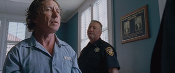 Movie still from “To the Wonder” (2012), directed by Terrence Malick – Two police officers standing next to each other in front of a window; Close Up shot, Low angle