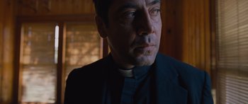 Movie still from “To the Wonder” (2012), directed by Terrence Malick – A man wearing a priest's outfit looking into the distance; Close Up shot, Low angle