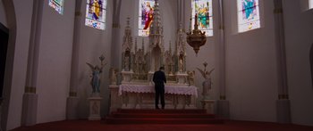 Movie still from “To the Wonder” (2012), directed by Terrence Malick – A man standing in front of a church alter; Wide shot, Low angle