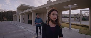 Movie still from “To the Wonder” (2012), directed by Terrence Malick – A man and a woman walking down a sidewalk; Wide shot, Over the shoulder angle