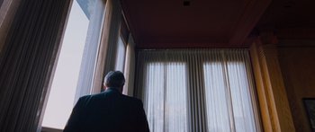 Movie still from “To the Wonder” (2012), directed by Terrence Malick – A man standing in front of a large window; Wide shot, Low angle