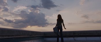 Movie still from “To the Wonder” (2012), directed by Terrence Malick – A woman standing on the edge of a building looking out at the sky; Wide shot, Low angle