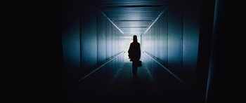 Movie still from “To the Wonder” (2012), directed by Terrence Malick – A person is walking in a dark tunnel; Wide shot, Low angle