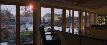 Movie still from “To the Wonder” (2012), directed by Terrence Malick – A person standing in a sunbeam near a window; Extreme Wide shot, Low angle