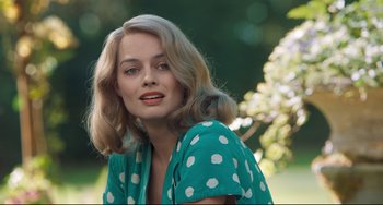 Movie still from “Goodbye Christopher Robin” (2017), directed by Simon Curtis – A woman with blonde hair wearing a green polka dot shirt; Close Up shot, Over the shoulder angle