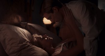 Movie still from “Goodbye Christopher Robin” (2017), directed by Simon Curtis – A man and a woman laying in a bed together; Medium shot, Low angle