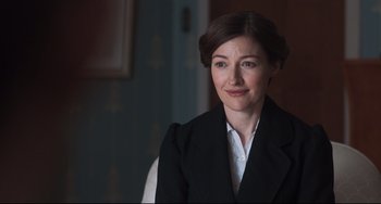 Movie still from “Goodbye Christopher Robin” (2017), directed by Simon Curtis – A woman wearing a suit and a white shirt; Close Up shot, Over the shoulder angle