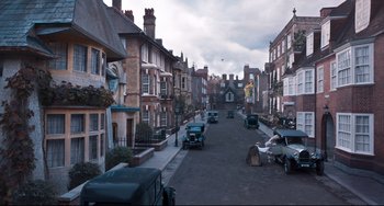 Movie still from “Goodbye Christopher Robin” (2017), directed by Simon Curtis – A street scene with cars parked on the side of the road; Extreme Wide shot, High angle