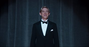 Movie still from “Goodbye Christopher Robin” (2017), directed by Simon Curtis – A man wearing a tuxedo and a bow tie; Medium shot, Low angle