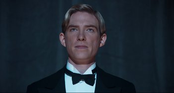 Movie still from “Goodbye Christopher Robin” (2017), directed by Simon Curtis – A person wearing a suit and bow tie; Close Up shot, Low angle