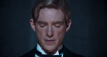 Movie still from “Goodbye Christopher Robin” (2017), directed by Simon Curtis – A person wearing a suit and bow tie; Close Up shot, Low angle