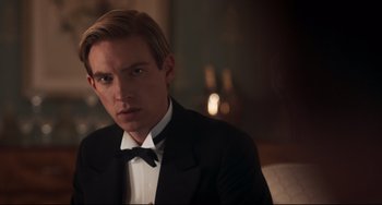 Movie still from “Goodbye Christopher Robin” (2017), directed by Simon Curtis – A man in a tuxedo sitting in a chair in front of a mirror; Close Up shot, Over the shoulder angle
