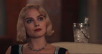 Movie still from “Goodbye Christopher Robin” (2017), directed by Simon Curtis – A woman with blonde hair wearing a black dress; Close Up shot, Over the shoulder angle