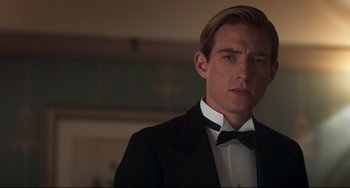 Movie still from “Goodbye Christopher Robin” (2017), directed by Simon Curtis – A man wearing a tuxedo and a bow tie; Close Up shot, Low angle