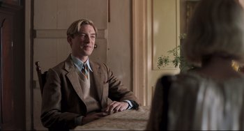 Movie still from “Goodbye Christopher Robin” (2017), directed by Simon Curtis – A man sitting at a table in front of a mirror; Medium shot, Over the shoulder angle