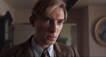 Movie still from “Goodbye Christopher Robin” (2017), directed by Simon Curtis – A person wearing a suit and tie; Close Up shot, Low angle