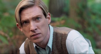 Movie still from “Goodbye Christopher Robin” (2017), directed by Simon Curtis – A person wearing a suit and tie; Close Up shot, Over the shoulder angle