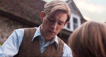 Movie still from “Goodbye Christopher Robin” (2017), directed by Simon Curtis – A young man in a vest and a blue dress shirt; Close Up shot, Over the shoulder angle