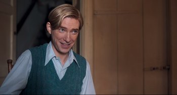 Movie still from “Goodbye Christopher Robin” (2017), directed by Simon Curtis – A person wearing a vest; Medium shot, Over the shoulder angle