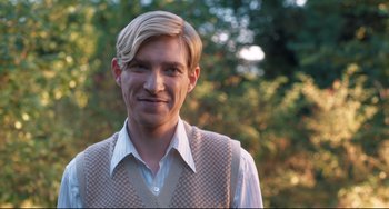 Movie still from “Goodbye Christopher Robin” (2017), directed by Simon Curtis – A man with blonde hair wearing a vest; Close Up shot, Over the shoulder angle