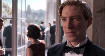 Movie still from “Goodbye Christopher Robin” (2017), directed by Simon Curtis – A person wearing a suit and a bow tie; Close Up shot, Over the shoulder angle