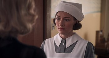 Movie still from “Goodbye Christopher Robin” (2017), directed by Simon Curtis – A woman wearing a nurse's uniform and a white hat; Close Up shot, Over the shoulder angle