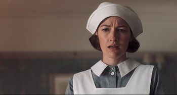 Movie still from “Goodbye Christopher Robin” (2017), directed by Simon Curtis – A woman wearing a white hat and a white apron; Close Up shot, Low angle