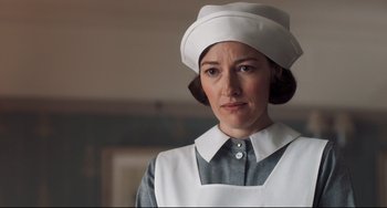 Movie still from “Goodbye Christopher Robin” (2017), directed by Simon Curtis – A woman wearing a white hat and a white apron; Close Up shot, Low angle