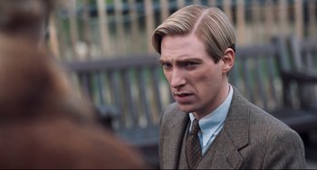 Movie still from “Goodbye Christopher Robin” (2017), directed by Simon Curtis – A person wearing a suit and tie; Close Up shot, Over the shoulder angle