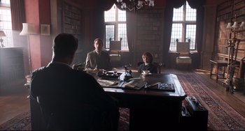 Movie still from “Goodbye Christopher Robin” (2017), directed by Simon Curtis – Two people sitting at a table in a room; Wide shot, Low angle