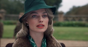 Movie still from “Goodbye Christopher Robin” (2017), directed by Simon Curtis – A woman wearing a green hat and a green scarf; Close Up shot, Over the shoulder angle
