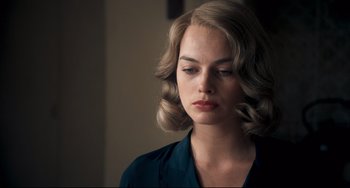 Movie still from “Goodbye Christopher Robin” (2017), directed by Simon Curtis – A beautiful young woman with blonde curly hair and blue eyes; Close Up shot, Over the shoulder angle