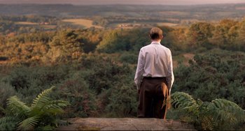 Movie still from “Goodbye Christopher Robin” (2017), directed by Simon Curtis – A man standing on top of a hill looking out over a valley; Wide shot, High angle