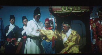 Movie still from “Goodbye, Dragon Inn” (2003), directed by Tsai Ming-liang – A group of men standing next to each other on a stage; Medium shot, High angle
