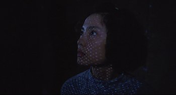 Movie still from “Goodbye, Dragon Inn” (2003), directed by Tsai Ming-liang – A woman is looking up at the sky; Close Up shot, Low angle