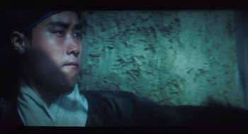Movie still from “Goodbye, Dragon Inn” (2003), directed by Tsai Ming-liang – A person wearing a suit and tie; Close Up shot, Low angle