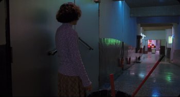 Movie still from “Goodbye, Dragon Inn” (2003), directed by Tsai Ming-liang – A woman standing in front of a door way; Wide shot, Low angle