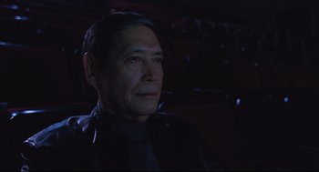 An older man is looking into the distance