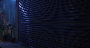 Movie still from “Goodbye, Dragon Inn” (2003), directed by Tsai Ming-liang – A dark blue metal wall; Extreme Wide shot, Low angle