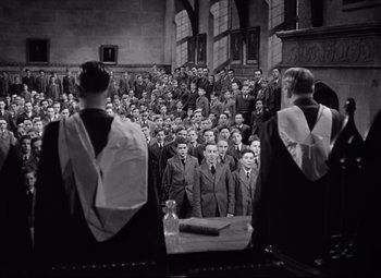 Movie still from “Goodbye, Mr. Chips” (1939), directed by Sam Wood – Black and white photograph of a group of people in a church; Wide shot, High angle