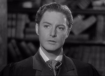 Movie still from “Goodbye, Mr. Chips” (1939), directed by Sam Wood – A black and white photo of a man in a suit and tie; Close Up shot, Low angle