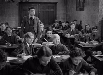 Movie still from “Goodbye, Mr. Chips” (1939), directed by Sam Wood – A group of people sitting in a classroom; Medium shot, High angle
