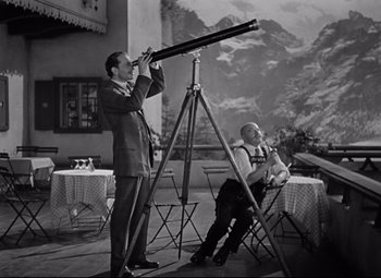 Movie still from “Goodbye, Mr. Chips” (1939), directed by Sam Wood – Two men are looking through a telescope in a room; Medium shot, Low angle
