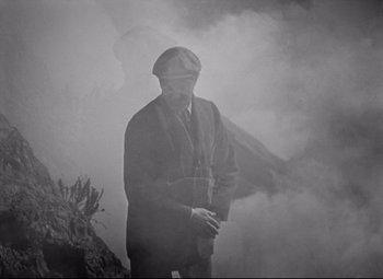 Movie still from “Goodbye, Mr. Chips” (1939), directed by Sam Wood – A black and white photo of a man standing in the fog; Medium shot, High angle