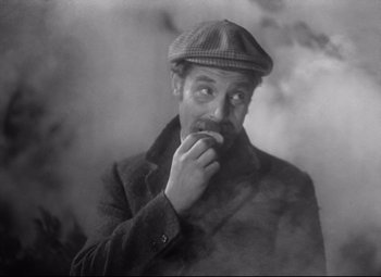 Movie still from “Goodbye, Mr. Chips” (1939), directed by Sam Wood – An old man wearing a hat and a coat; Close Up shot, High angle